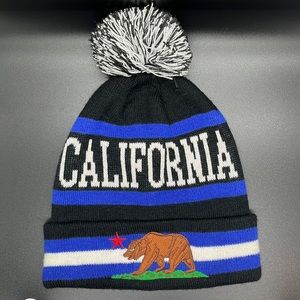 Black and blue California puffball beanie with bear
